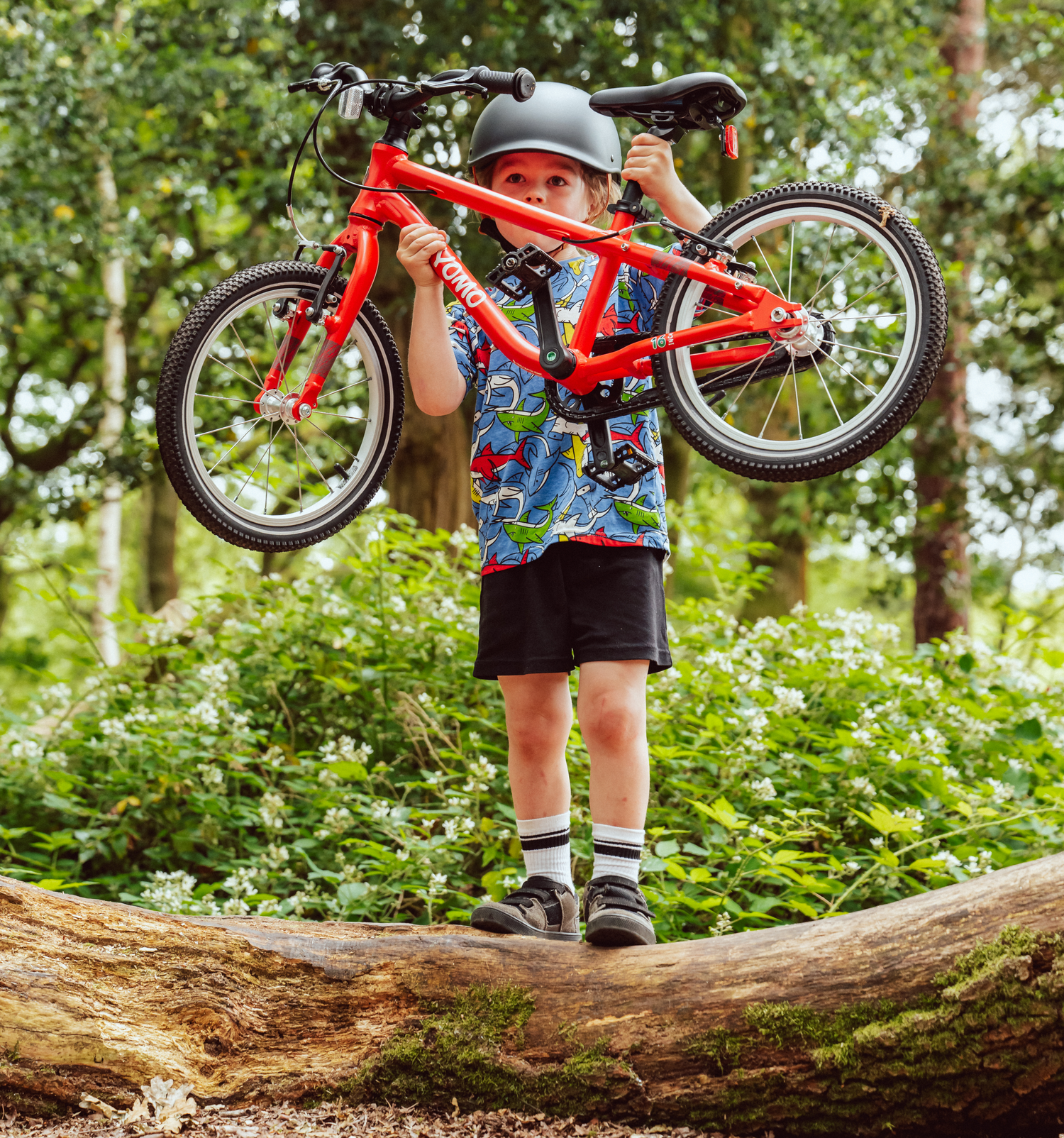 Child confidently riding a YOMO bike